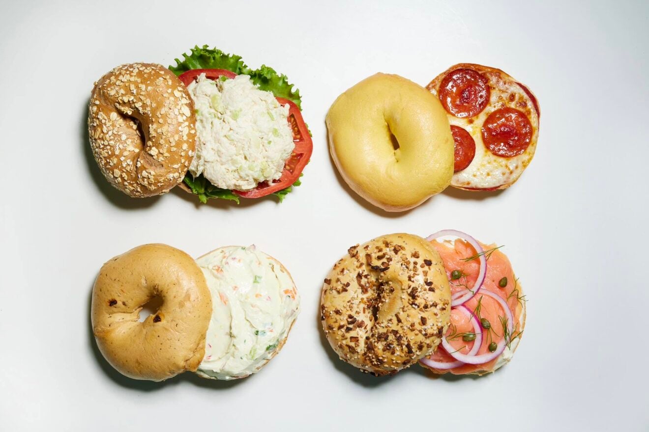 Four bagel halves: chicken salad, pepperoni pizza bagel, vegetable cream cheese, and lox with onion and capers