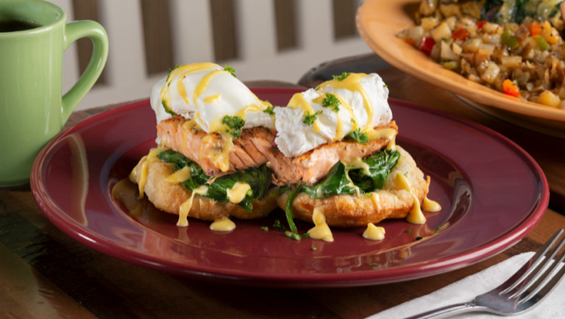 Salmon Benedict with hollandaise on a red plate, a Joe Louis Southern Kitchen dish