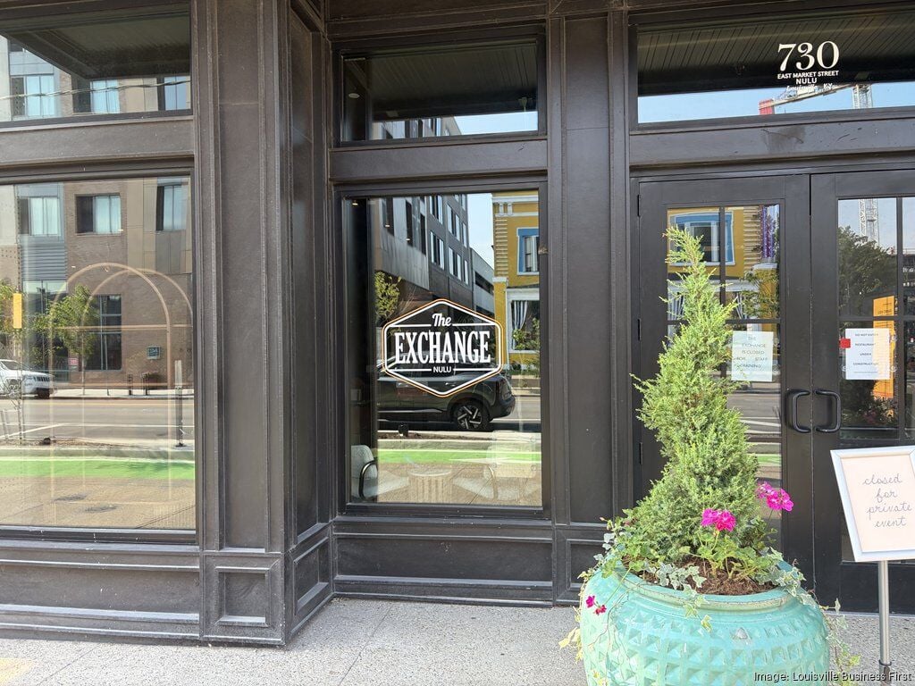 The Exchange NuLu storefront at 730 East Market Street, with training and construction signs still in the window