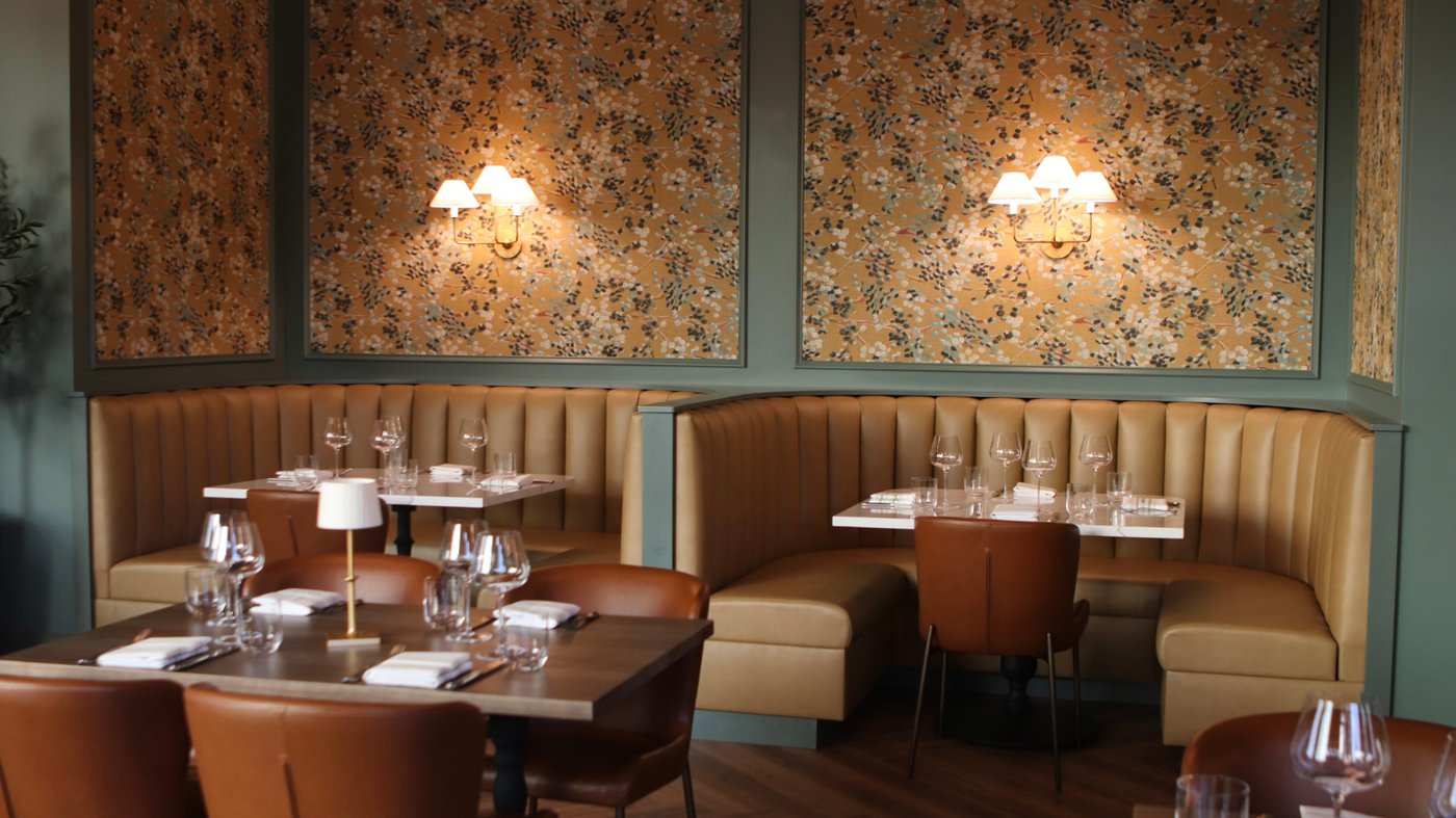 Tufted banquettes and floral panels in the Josephine Estelle dining room