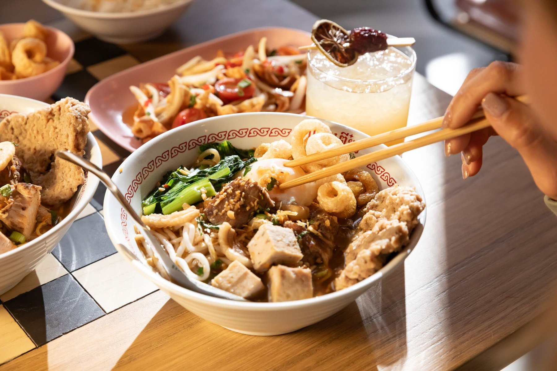 A bowl of Thai noodle soup at Guay Tiew, with pork, greens, and crispy rinds