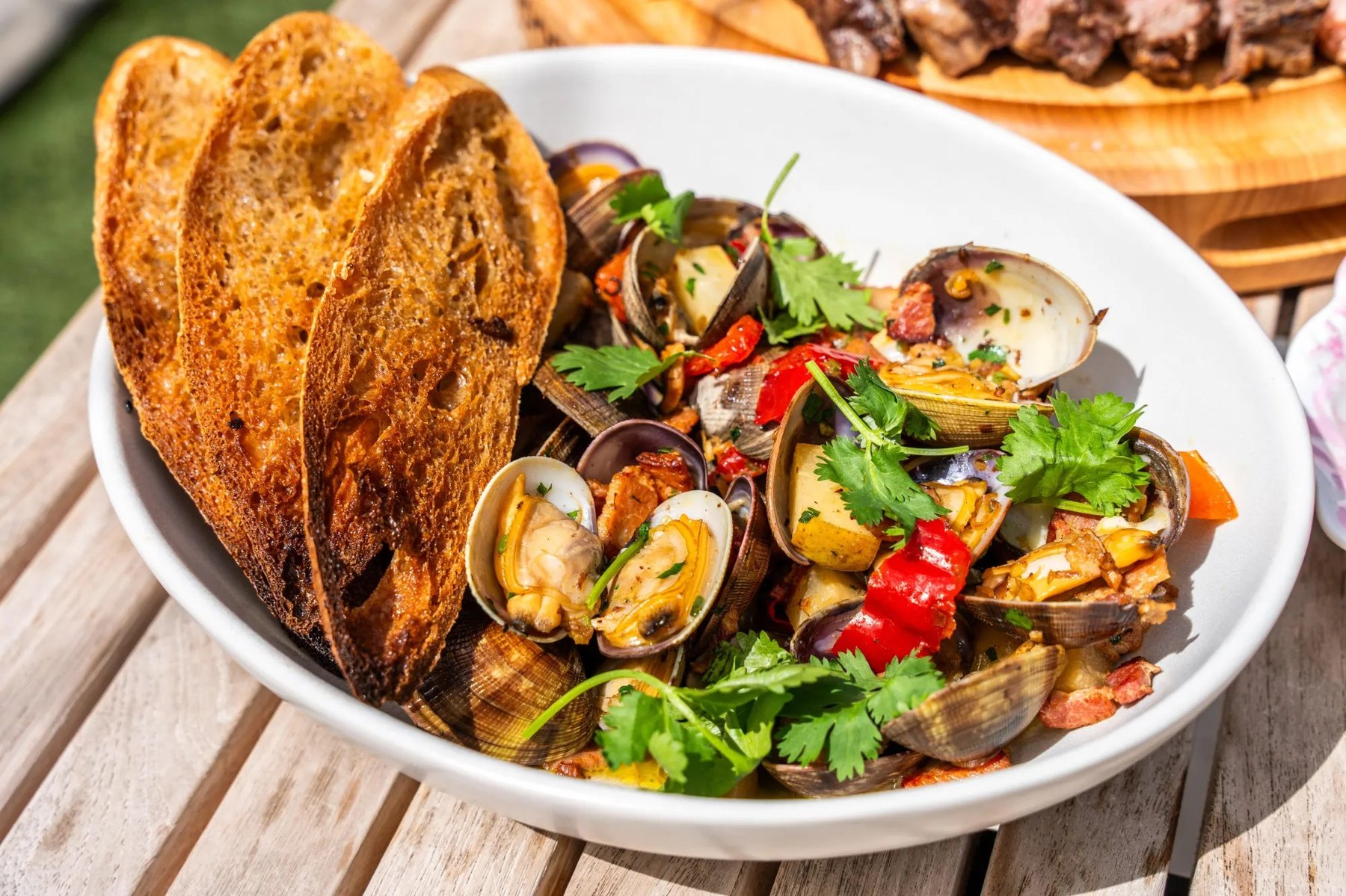 Manila clams with peppers, potatoes, parsley, and toasted sourdough at The Malarkey